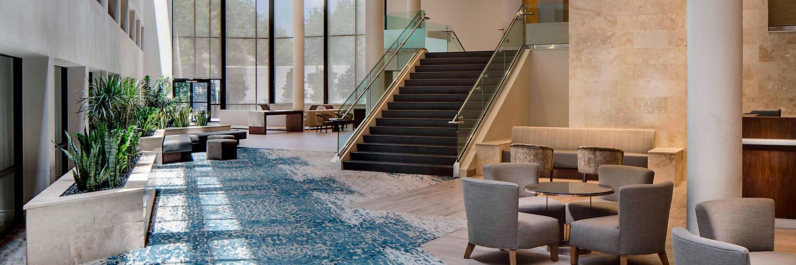 Atrium lobby of the San Antonio Marriott Northwest Medical Center &mdash; staircase, lounge seating and full-height glazing